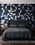 Ink & Oak Midnight oak leaf and berry wallpaper behind a tufted headboard in a dark, moody bedroom