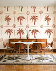 Ink & Shell Terracotta coastal palm and shell wallpaper in a mid-century dining room with a teak sideboard and tulip table