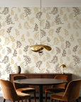 Ink & Sprig Bronze botanical sprig wallpaper behind a walnut credenza and round table in an elegant dining room