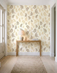 Ink & Sprig Bronze botanical sprig wallpaper behind a console table in a light entry hallway