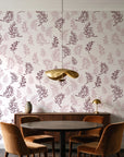 Ink & Sprig Burgundy botanical sprig wallpaper behind a walnut credenza and round table in an elegant dining room