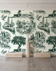 Inked Grove Forest pastoral toile wallpaper behind a travertine pedestal and vase in a minimal boutique
