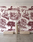 Inked Grove Oxblood pastoral toile wallpaper behind a travertine pedestal and vase in a minimal boutique