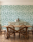 Khaki Leaf Evergreen botanical leaf wallpaper in a farmhouse dining room with a sage sideboard and rustic trestle table