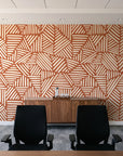 Kinetic Etch Terracotta hand-drawn lines wallpaper above a walnut credenza in a modern conference room