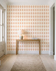 Linen Diamonds Terracotta argyle wallpaper behind a console table in a light entry hallway