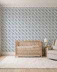 Linen & Leaf Indigo leaf wallpaper in a calm, light-filled nursery