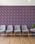 Linen & Leaf Plum leaf wallpaper behind a row of upholstered chairs in a bright clinic waiting room