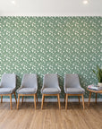 Linen & Leaf Sage leaf wallpaper behind a row of upholstered chairs in a bright clinic waiting room