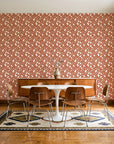 Linen & Leaf Terracotta leaf wallpaper in a mid-century dining room with a teak sideboard and tulip table