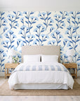Meadow Light Cornflower meadow flower wallpaper behind a queen bed in a bright coastal bedroom