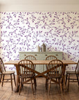 Meadow Wander Plum floral vine wallpaper in a farmhouse dining room with a sage sideboard and rustic trestle table
