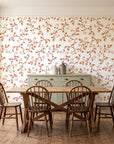 Meadow Wander Terracotta floral vine wallpaper in a farmhouse dining room with a sage sideboard and rustic trestle table