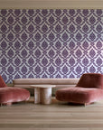 Misty Fern Romance Plum damask wallpaper in a boutique hotel sitting area