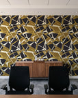 Muted Block Graphite geometric wallpaper above a walnut credenza in a modern conference room