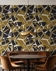 Muted Block Graphite geometric wallpaper behind a walnut credenza and round table in an elegant dining room