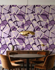 Muted Block Plum geometric wallpaper behind a walnut credenza and round table in an elegant dining room