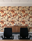 Muted Block Terracotta geometric wallpaper above a walnut credenza in a modern conference room