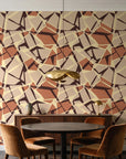 Muted Block Terracotta geometric wallpaper behind a walnut credenza and round table in an elegant dining room