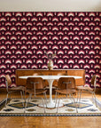 Ocean Fortress Oxblood art deco scale wallpaper in a mid-century dining room with a teak sideboard and tulip table