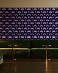 Ocean Fortress Plum art deco scale wallpaper in an intimate luxury cocktail lounge