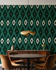 Ogee Loom Emerald ikat ogee wallpaper behind a walnut credenza and round table in an elegant dining room
