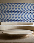 Ogee Loom Indigo ikat ogee wallpaper in an elegant living room