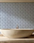 Olive Fret Charcoal geometric fret wallpaper creating ambiance in a serene spa bathroom