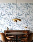Pale Foliage Delft willow leaf wallpaper behind a walnut credenza and round table in an elegant dining room