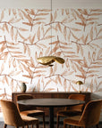 Pale Foliage Terracotta willow leaf wallpaper behind a walnut credenza and round table in an elegant dining room