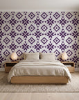 Pale Kilim Plum kilim wallpaper behind a low platform bed in a serene Japandi bedroom