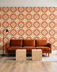 Pale Kilim Terracotta kilim wallpaper behind a rust velvet sofa in a bright coworking lounge