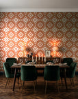 Pale Kilim Terracotta kilim wallpaper in a dark moody dining room with a candlelit table