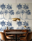 Palm Shade Navy palm grove wallpaper behind a walnut credenza and round table in an elegant dining room