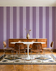 Parlor Stripe Plum geometric stripe wallpaper in a mid-century dining room with a teak sideboard and tulip table