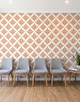Pastel Bouquet Parade Terracotta botanical damask wallpaper behind a row of upholstered chairs in a bright clinic waiting room