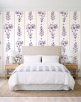 Petal & Thread Plum botanical stem wallpaper behind a queen bed in a bright coastal bedroom