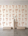 Petal & Thread Terracotta botanical stem wallpaper behind a travertine pedestal and vase in a minimal boutique