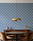 Petal Dawn Slate art deco fan wallpaper behind a walnut credenza and round table in an elegant dining room