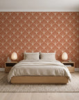 Petal Dawn Terracotta art deco fan wallpaper behind a low platform bed in a serene Japandi bedroom