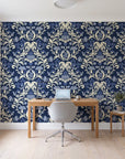 Petal Reflection Midnight floral damask wallpaper behind a modern oak desk in a bright home office