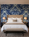 Petal Reflection Midnight floral damask wallpaper behind the headboard of a king bed in a contemporary hotel guest room