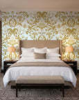 Petal Reflection Ochre floral damask wallpaper behind the headboard of a king bed in a contemporary hotel guest room