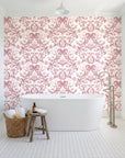 Petal Reflection Rose floral damask wallpaper behind a freestanding tub in a bright coastal bathroom