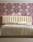 Petal Symphony Rosewood baroque damask wallpaper behind a channel-tufted bed in a calm primary bedroom