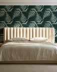 Pewter Fern Pine fern wallpaper behind a channel-tufted bed in a calm primary bedroom