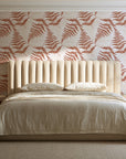 Pewter Fern Terracotta fern wallpaper behind a channel-tufted bed in a calm primary bedroom