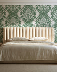 Poet's Blossom Sage classic damask wallpaper behind a channel-tufted bed in a calm primary bedroom