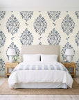 Porcelain Bouquet Inkwell damask wallpaper behind a queen bed in a bright coastal bedroom