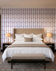 Quiet Grace Oxblood minimalist arch wallpaper behind the headboard of a king bed in a contemporary hotel guest room